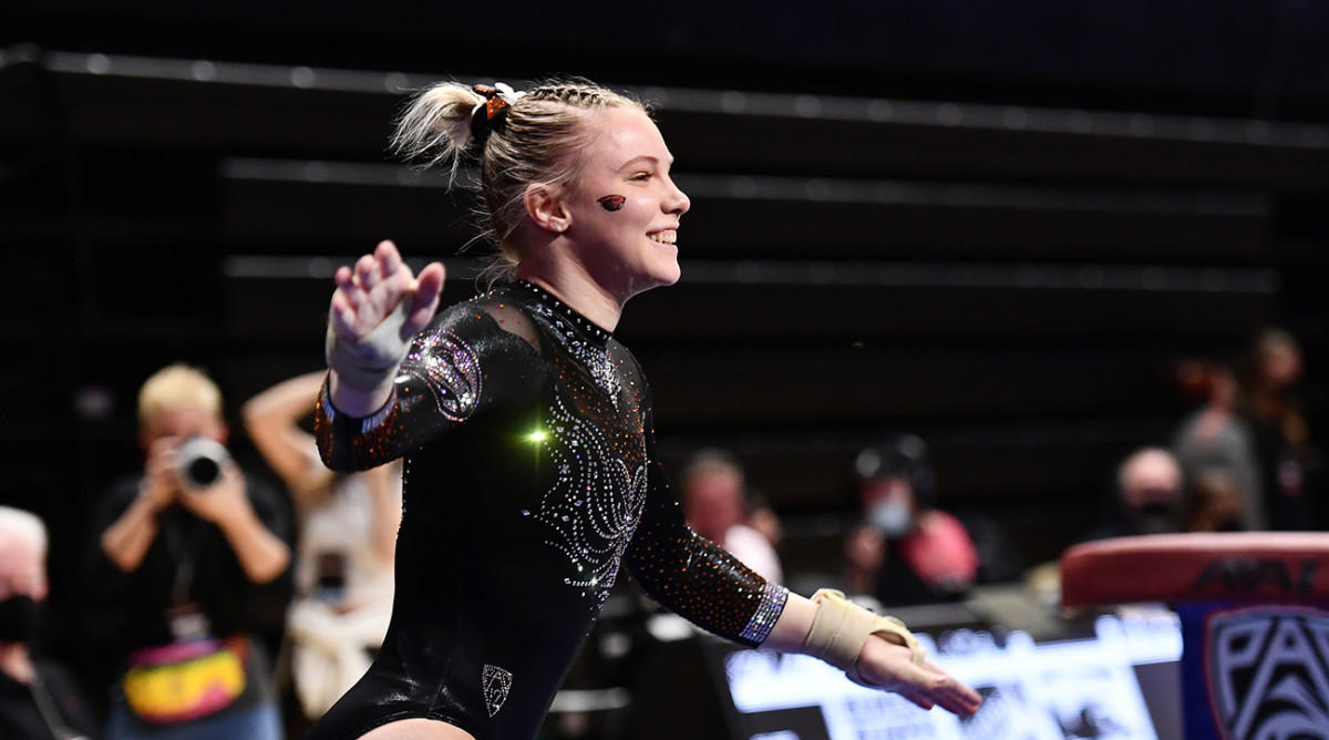 Jade Carey smiles after completing a routine during an Oregon State gymnastics competition.